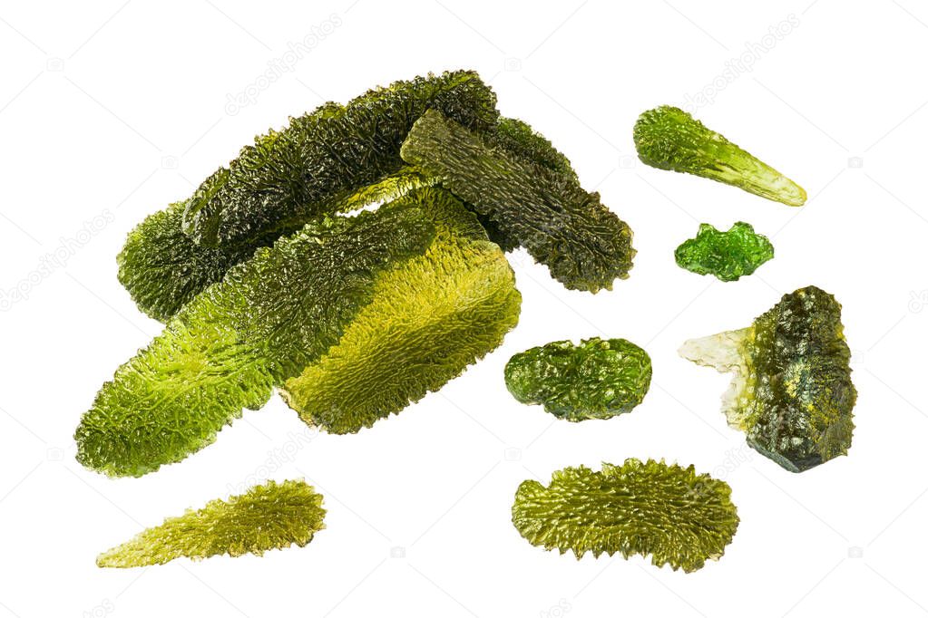 Group of rare green moldavite semi-precious stones isolated on white background. Various shaped raw gems of cosmic glass with rough mossy surface. Beautiful quartz collection of South Bohemia origin.
