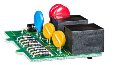 Electronic components on green circuit board isolated on a white background. Row of semiconductor diodes, colored thermistors and metal oxide varistors or black connectors in data link surge protector. clipart