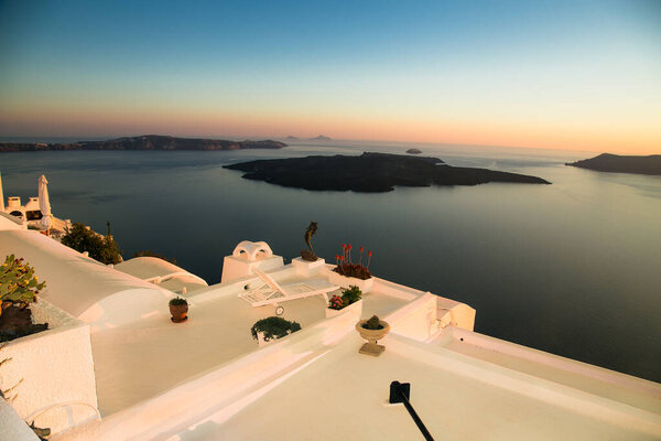 Overlooking from the hotel terrace in famous sunset at Santorini island, Greece, 