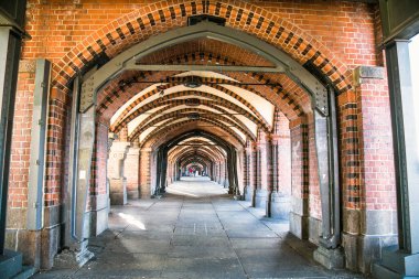 Kimliği belirsiz insanlarla Oberbaum Köprüsü. Spree Nehri 'ni geçen çift güverteli köprü, Almanya' nın Berlin kentinde bir şehir simgesi olarak kabul edilir. Friedrichshain n Kreuzberg ile bağlantılı.