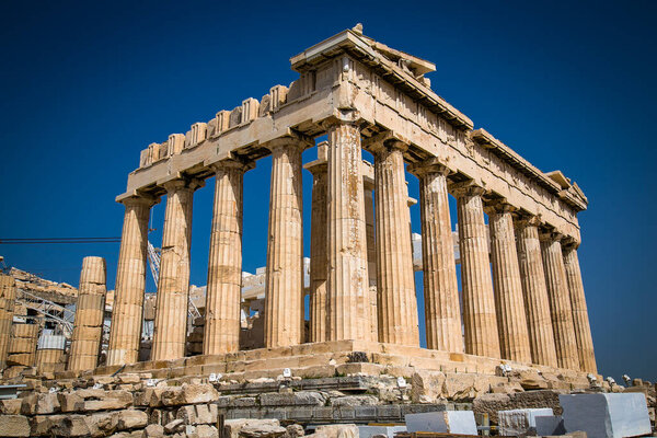 Parthenon on the Acropolis of Athens, Greece. The famous ancient Greek Parthenon is the main landmark of Athens. Ruins of Parthenon or temple of Athena at the top of mountain