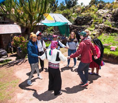 Taquile, Peru - 5 Ocak 2019: Taquile Adası 'na özgü geleneksel kıyafetli tanımlanamayan müzisyen ve dansçılar. Peru.