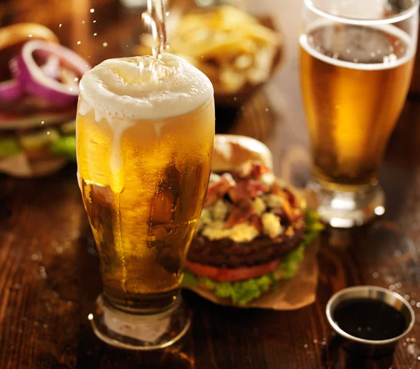 Beer being poured into glass — Stock Photo, Image