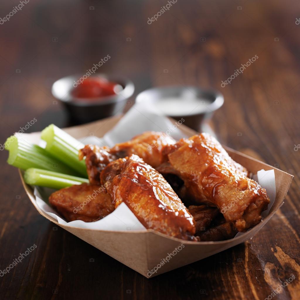 Buffalo chicken wings in basket with celery — Stock Photo © resnick