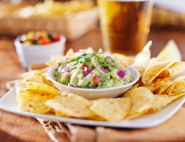 Guacamole with tortilla chips and beer — Stock Photo, Image