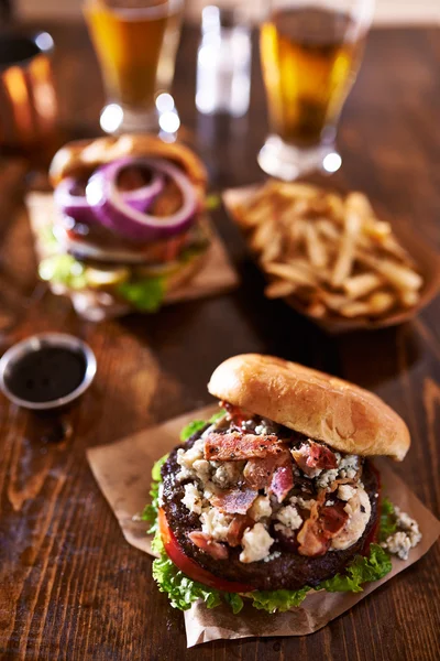 Two gourmet cheeseburgers with beer — Stock Photo, Image