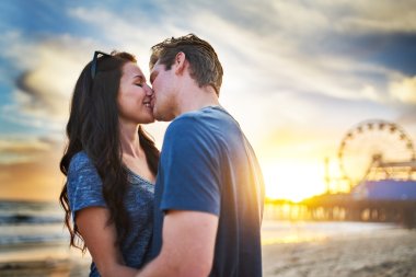 happy couple kissing on beach clipart