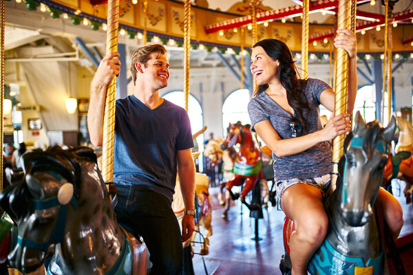 romantic couple riding carousel