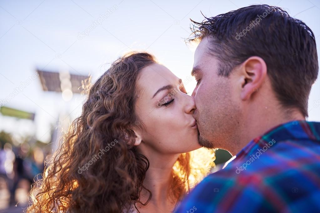 couple kissing in public together