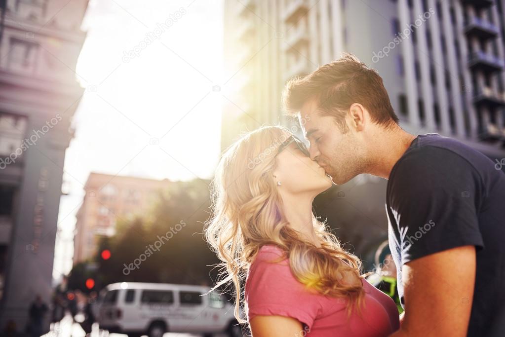 romantic couple kissing in downtown