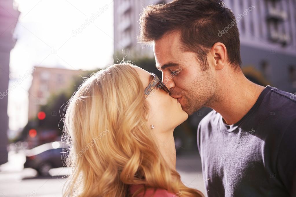 couple kissing on street 