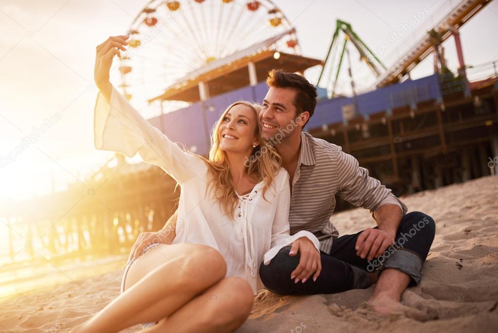 happy romantic couple taking selfie