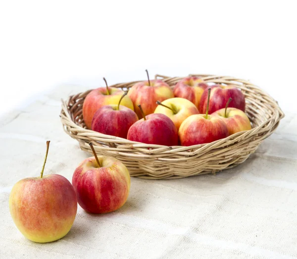 Small gala apple in basket on sack over white. — Stock Photo, Image