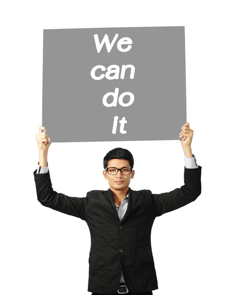 Asia businessman show wording we can do it on paper board — Stock Photo, Image