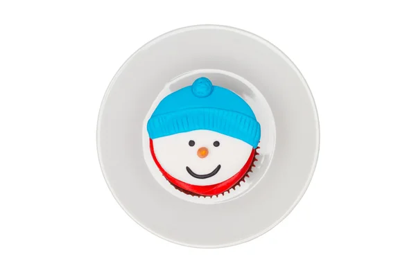 Christmas cupcake with butter cream icing on the saucer. Snowman — Stock Photo, Image