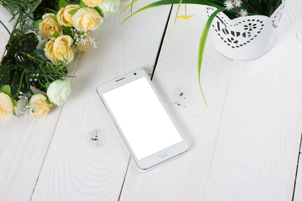 Smart phone with blank screen lying on wooden table — Stock Photo, Image