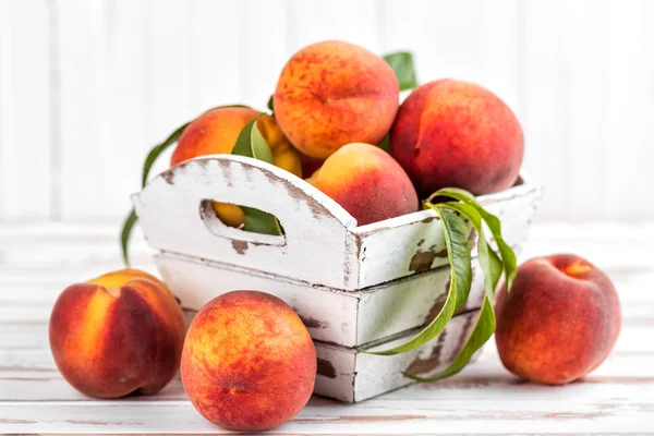 Fresh peaches on wooden background — Stock Photo, Image