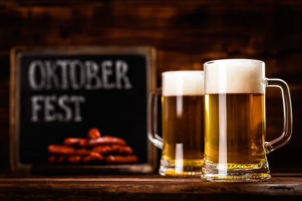 Oktoberfest background with two mugs of beer — Stock Photo, Image