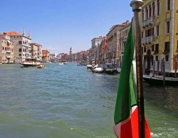 Italian flag and Venice canal on background
