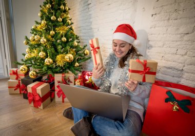 Mutlu kadın yalnız başına sanal Noel videosunu kutluyor ailesini ve arkadaşını arıyor. Koronavirüs karantinası, sosyal uzaklık ve yeni kısıtlamalar nedeniyle sanal tatil buluşması çevrimiçi.