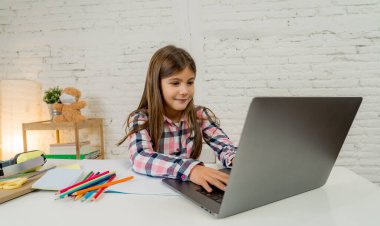 Bilgisayardaki Happy Liseli Kız son koronavirüs kilitlenmesi nedeniyle okullar kapalı kaldığı için evdeki internetteki sanal uzak bir sınıfta ders çalışıyor. COVID-19, eğitim, çocuklar ve E-öğrenim.