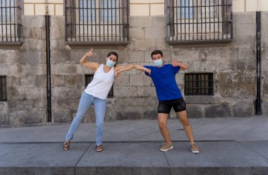 Yeni Normal ve selamlama tarzı. Erkek ve kadın, Coronavirus 'un yayılmasını önlemek için dirseklerini ya da ayaklarını sallayarak sosyal mesafeyi koruyorlar. COVID-19 salgını ve hastalık koruması.