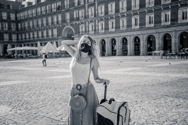 Happy Tourist in madrid, Spain Europe, traveling during post-covid summer holidays. Woman wearing face mask taking selfie happy to be able to travel over the summer. Travel safe after covid-19