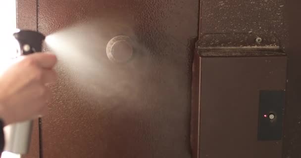 Womans hand sprays disinfectant the doors handle before touching. — Stock Video