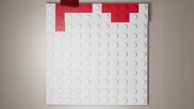 Kırmızı yapı taşları ile oluşturulan sembol duruşu.