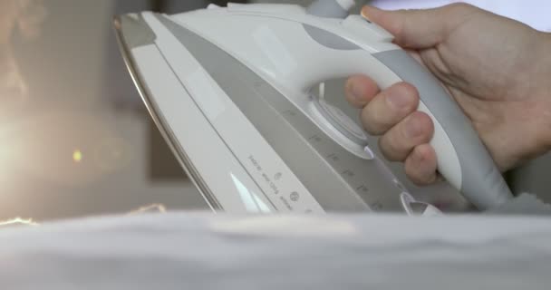 Ironing clothes on ironing board. — Stock Video