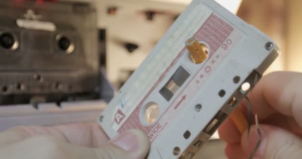 Manually rewind a cassette tape with a pencil. — Stock Video