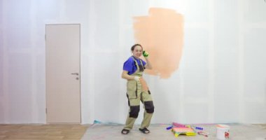 Güzel ressam kadın dairede tamirat yapıyor ve dans ediyor.. 