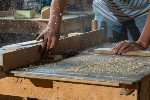 A carpenter works on woodworking the machine tool. Carpenter working on woodworking machines in carpentry shop. — Stock Photo, Image