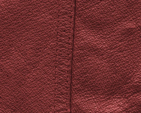 Red leather texture or background, seam — Stock Photo, Image