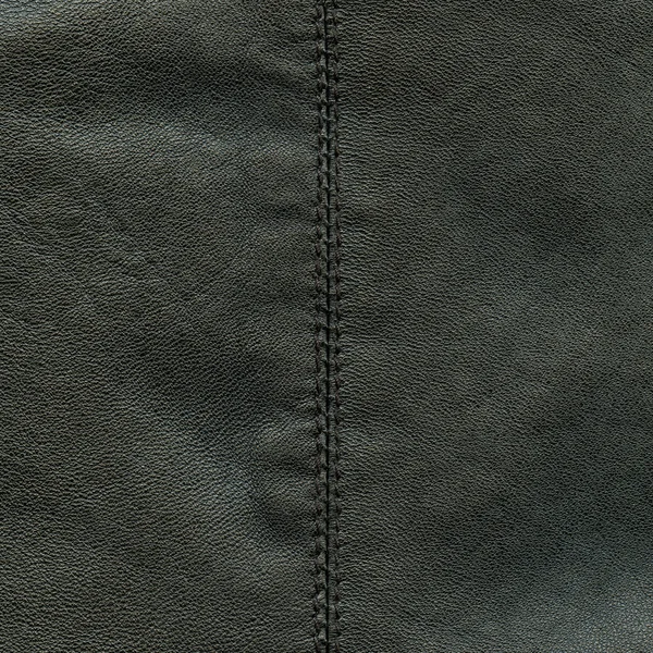 Black leather texture decorated with seam — Stock Photo, Image