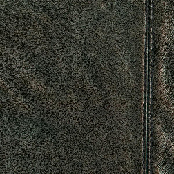 Greenish-brown leather texture decorated with seam — Stock Photo, Image