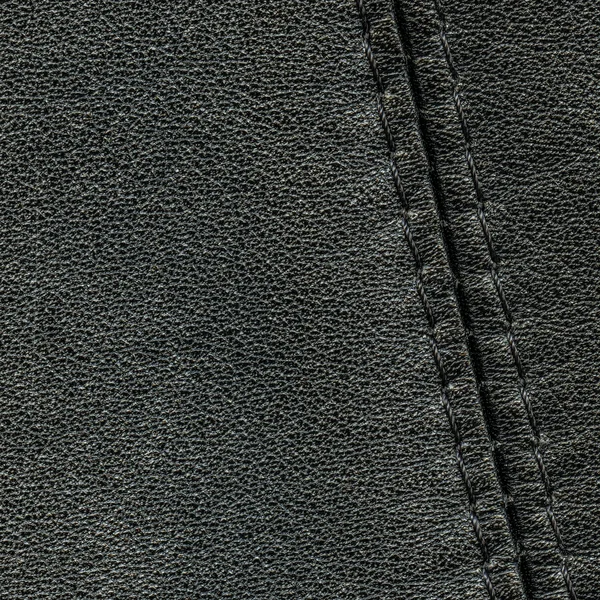 Black leather background  decorated with a seam — Stock Photo, Image