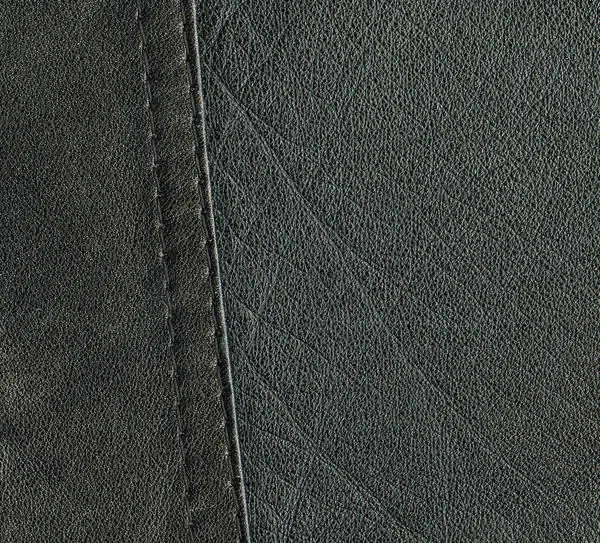 Black leather texture decorated with seam — Stock Photo, Image