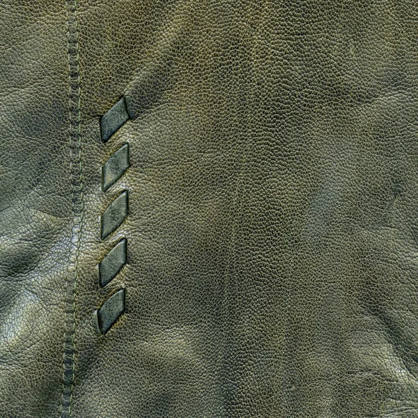 Fragment of old gray-green leather glove as background — Stock Photo, Image