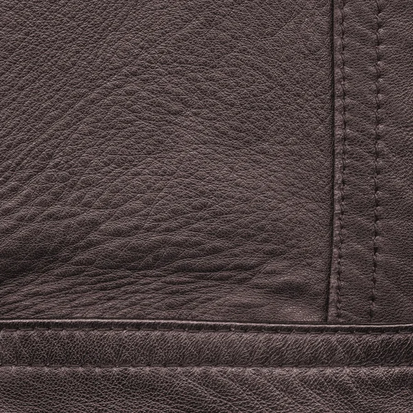 Brown leather background decorated with seams — Stock Photo, Image