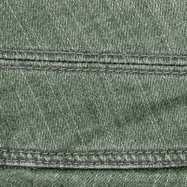 Зеленый джинсовой фон, украшенный швом — стоковое фото