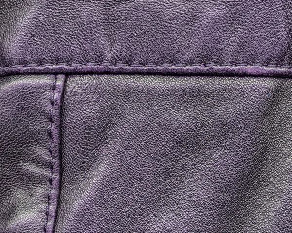 Violet leder textuur close-up, naden. Nuttig als achtergrond — Stockfoto