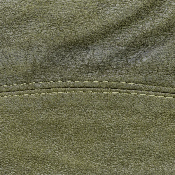 Groene gelooid leder texture versierd met naad — Stockfoto