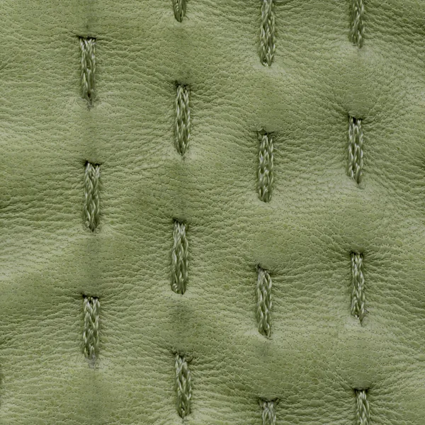 Green leather texture decorated with stitches — Stock Photo, Image