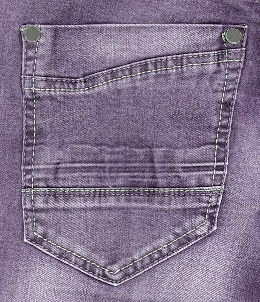 Violet pocket on jeans background — Stock Photo, Image