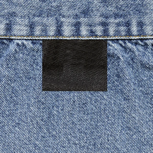 Black tag and  blue jeans texture