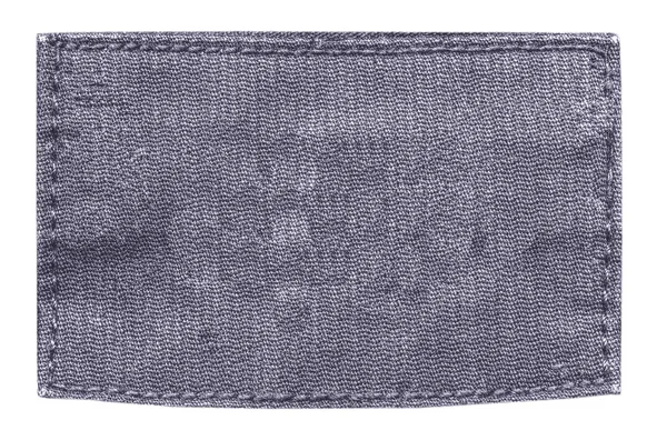 Etiqueta de tela gris-violeta en blanco — Foto de Stock