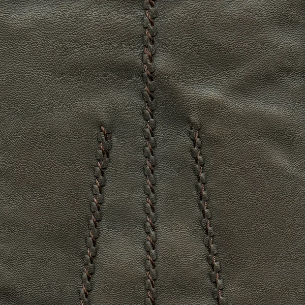 Dark brown leather texture decorated with seams — Stock Photo, Image