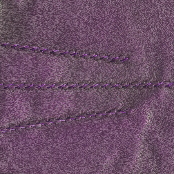 Violet leather texture decorated with seams — Stock Photo, Image