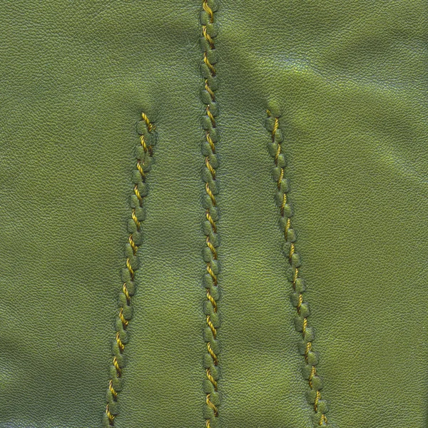 Green leather texture decorated with seams — Stock Photo, Image